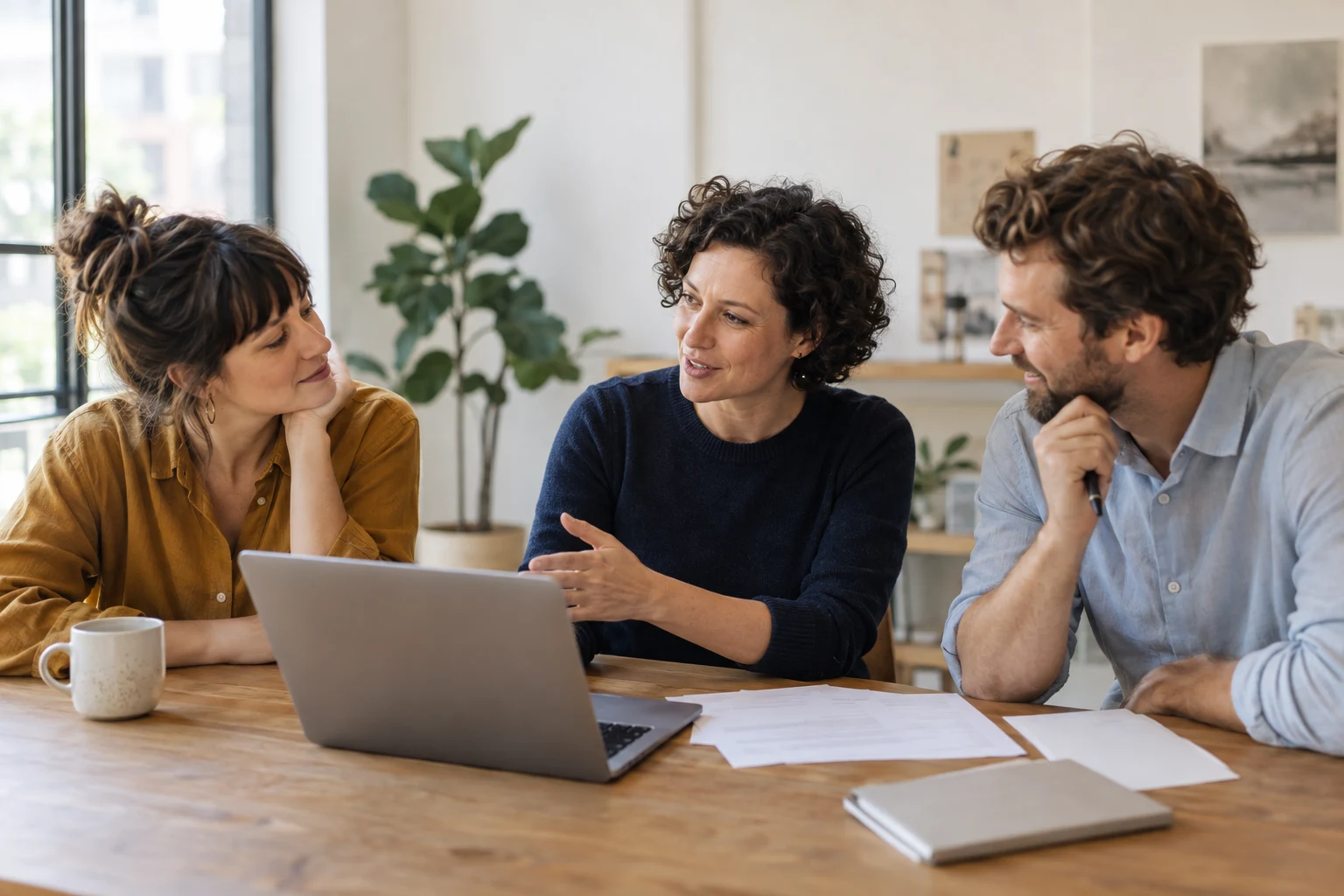 Mia, a Good Measure accountant, talking through a laptop with two small-business owners